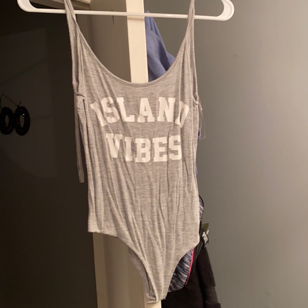 Light grey bodysuit with white lettering